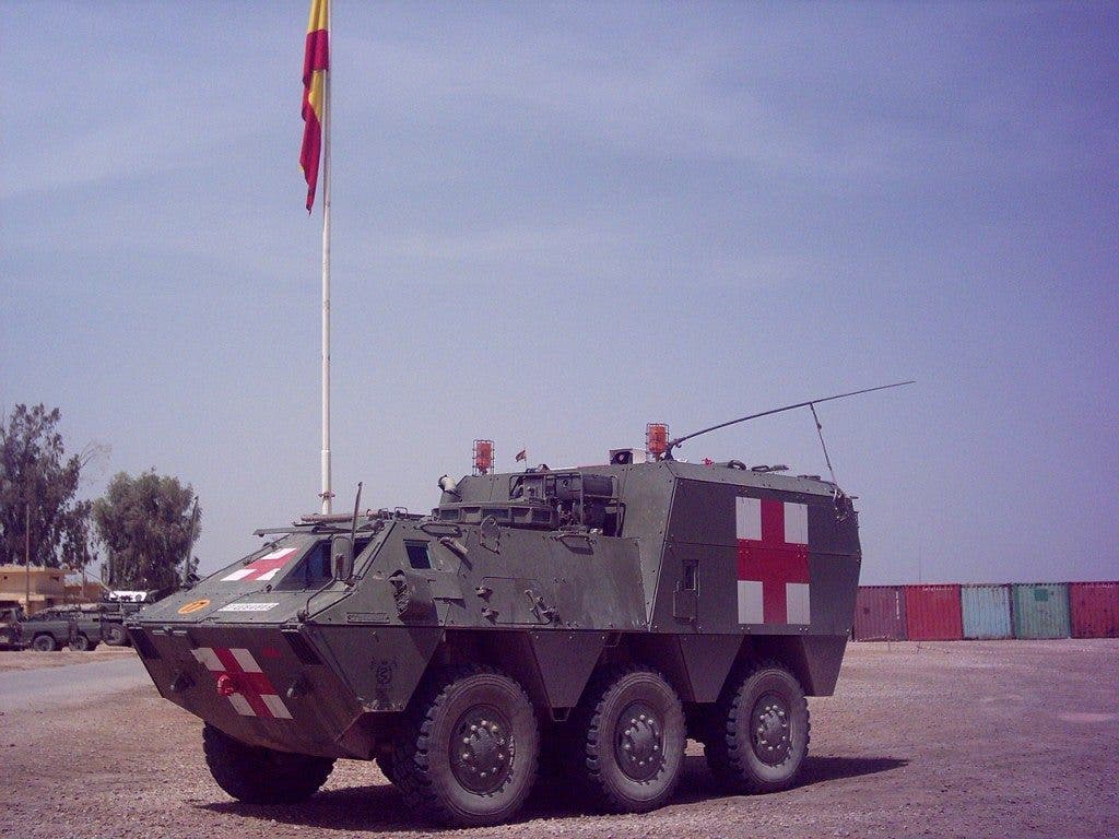 Un blindado con el símbolo del ejército español con el símbolo de la Cruz Roja Internacional